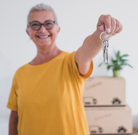 Older woman holding out keys
