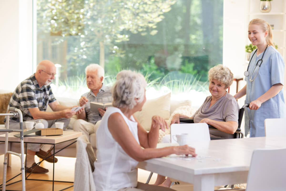 Things to Consider Assisted Living, five seniors in a common space in an assisted living community